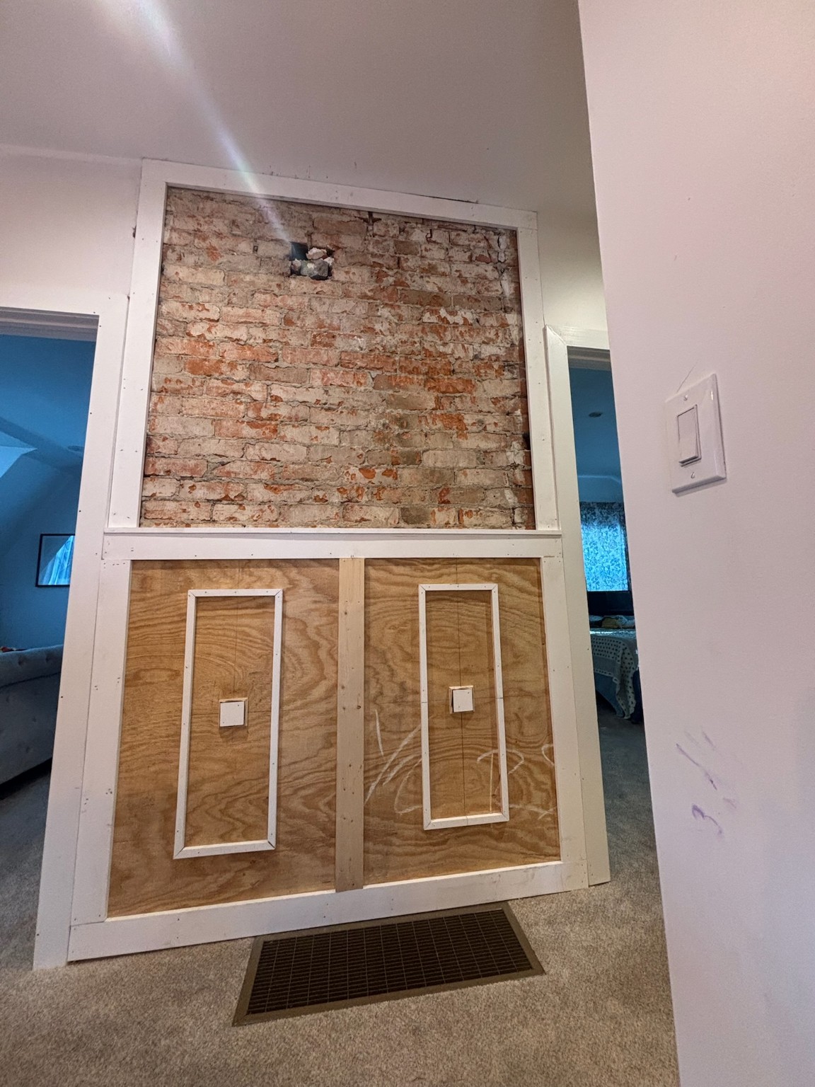Brick feature wall in progress — structural craftsmanship phase