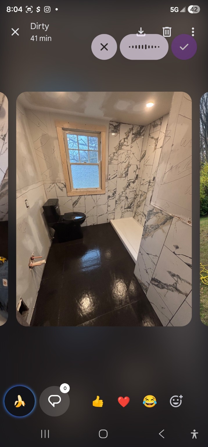 Luxury bathroom remodel — marble walls, black floor